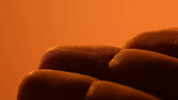 Detailed drawing of the skin of the fingers. Human closeup medicine skin. Healthy naked surface. Orange light.