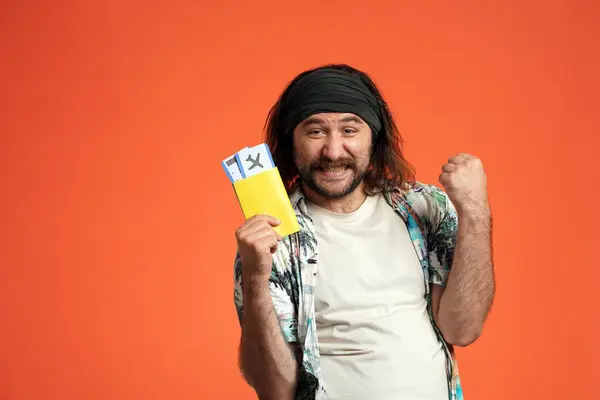 Longhaired Man Bandana Holds Passport Airline Tickets Makes Victory Gesture — Stock Photo, Image