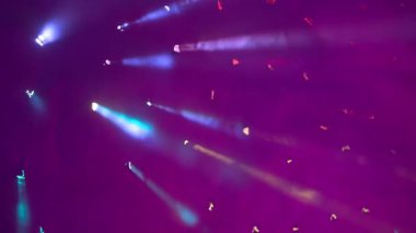 Mor, koyu arkaplandaki parlak ışıkta dumanı kıran, arka planı bulanıklaştıran. Soyut bir ekran koruyucu ya da resim, bir şey için bir desen sunar.