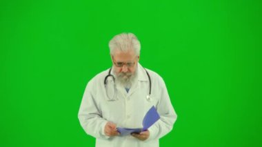 Sağlık ve tıbbi danışmanlık reklam konsepti. Krom anahtar yeşil ekranda insan sıhhiyesinin portresi. Üniformalı kıdemli doktoru kapat defterdeki belgeleri oku, çalış.