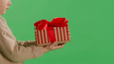 Stüdyodaki sarı arka plan duvarına izole edilmiş bir şekilde poz veren küçük şirin bir kız çocuğu. Noel konsepti.