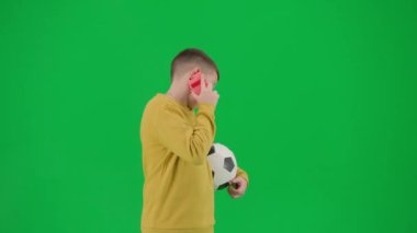 Modern çocuk okulu ve eğlence zamanı reklam konsepti. Krom anahtar yeşil ekrandaki çocuk portresi. Okul çocuğu futbol topu tutuyor ve aileleriyle akıllı telefondan konuşuyor. Orta çekim.