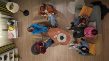 Oturma odasında oturan kız öğrencilerin en iyi görüntüsü. Genç bayanlardan biri akıllı telefon kullanıyor. Kız online bir oyun veya kumarhane kazanarak zafer jesti yapıyor, diğer kadınlar tebrik ediyor.