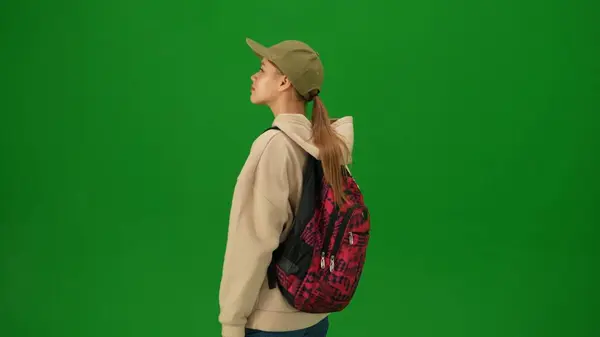 stock image Airport creative advertisement concept. Portrait of person tourist isolated on chroma key green screen background. Close up shot young woman standing and looking at the departure board.