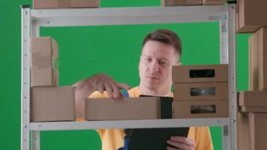 Yeşil arka planda çerçevelenmiş, kromakey. İfade, iş üniformalı bir adamdır. Depoda bir depocuyu gösteriyor. Bir kutu arıyor, bir kutu buluyor, değiştiriyor, panoya işaretliyor ve gidiyor..