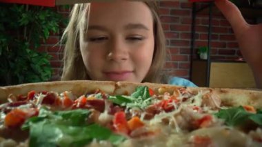 Aşırı gurme bakış açısı yaratıcı reklam konsepti. Farklı lezzetli yiyecekler yiyen insanlara yakın çekim. Konteynırdan bakınca, kız pizza kutusunu açıyor, şaşkın bir yüz ifadesi var. POV.