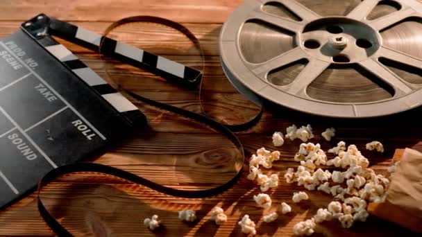 Clapper Board Film Reel Next Bag Fresh Popcorn Wooden Table — Stock Video