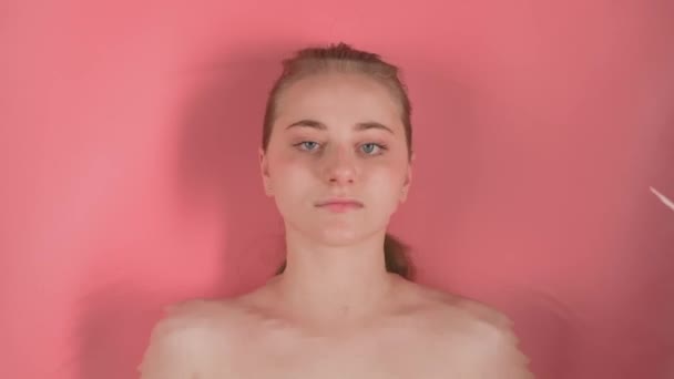 Fondo Rosa Muestra Una Chica Atractiva Sin Maquillaje Ella Yace — Vídeos de Stock