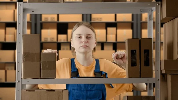 Business warehouse and logistics creative advertising concept. Portrait of a female working in a warehouse. Uniformed warehouse girl
