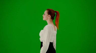 Modern iş kadını yaratıcı reklam konsepti. Krom anahtar yeşil ekranda çekici ofis kızı portresi. Etek ve bluz giyen kadın kurnazca yürüyor. Yan görünüm.