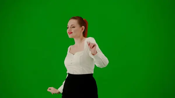Modern business woman creative advertisement concept. Portrait of attractive office girl on chroma key green screen. Woman in skirt and blouse walking cutely. Half turn.