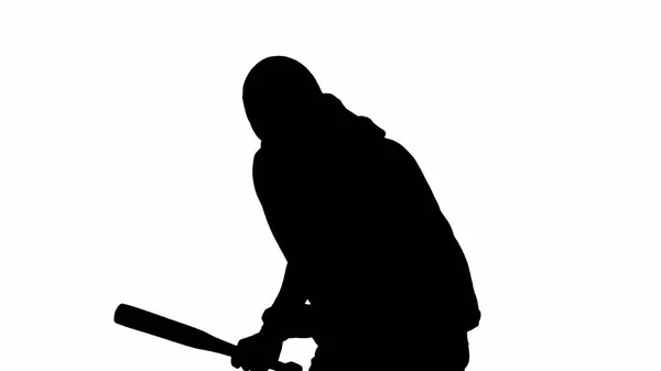 独立的白色背景上的小偷的黑色轮廓 一名身穿帽衫和巴拉克拉瓦的男子手持一根木棍走路 准备犯罪 转半圈 — 图库照片