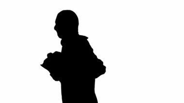 İzole edilmiş beyaz arka planda siyah bir hırsız silueti. Kapüşonlu ve kar maskeli bir erkek soyguncu elinde bir çantayla koşuyor. Suç ve hırsızlık kavramı. Yan görünüm