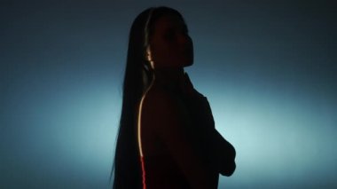 Güzellik vücudu estetik yaratıcı reklam konsepti. Stüdyoda kadın modelin portresi. Siluet çekici kadın beyaz düşük ışık arka planda poz, pürüzsüz cilt dokunma, seçici ışık ışını.
