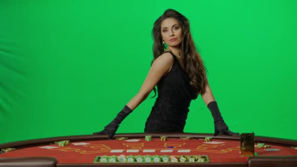赌场和赌博创意广告的概念 色键绿色屏幕上优雅的女性画像 迷人的女人站在21点扑克桌前 摆出一副相机的姿势 双手滑过桌子 — 图库视频影像