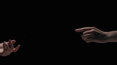 Vücut parçaları estetik güzellik ve cilt kreatif reklam konsepti. Stüdyoda siyah arka planda izole edilmiş kadın modelin portresi. Kadınlar ellerini birbirine uzatır ve hafifçe parmaklarına dokunur..