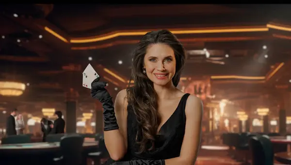 Chic woman in black dress at poker table for blackjack game in casino. The woman shows two aces on camera and smiles victoriously at her winnings. The concept of casino and gambling