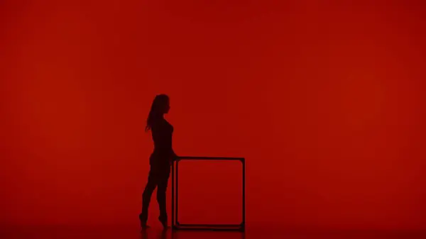 现代编舞和杂技创意广告的概念 女性杂技演员在红色霓虹灯背景下被隔离的轮廓 身穿紧身衣 在立方体上展示杂技元素的女子体操舞蹈家 — 图库照片