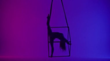 Modern koreografi ve akrobasi yaratıcı reklam konsepti. Kadın akrobatın silueti neon arka planda izole edildi. Kadın akeralist dansçı iplerle havada yarıklar açıyor..