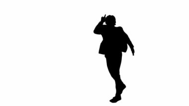 Modern iş adamı reklam konsepti. Stüdyodaki adam alfa kanallı beyaz arka planda izole edildi. Takım elbiseli bir iş adamının siyah silueti komik dans ediyor.