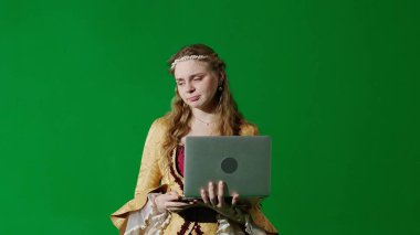 Tarihsel kişi modern yaşam tarzı reklamı. Krom anahtar yeşil ekran arka planda antik kıyafetli bir kadın. Rönesans tarzı elbise giymiş bir kadın dizüstü bilgisayarda mesaj yazıyor..