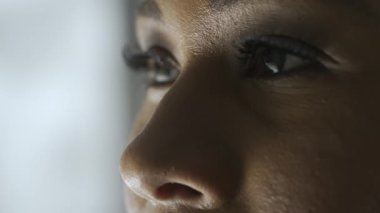 Cilt bakımı güzellik hizmetleri konsepti. Kadın modelin makro görüntüsü. Afro-Amerikalı kadın yüzünün makro görüntüsü, gözlere odaklan, manken kameradan başka yere baksın..