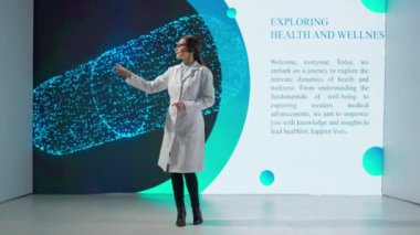 Beyaz önlüklü profesyonel bir kadın büyük bir dijital ekranda bir uyuşturucu ürününün önünde bilimsel bir konferans veriyor. Tıp, sağlık ve sağlık hizmetleri kavramı.