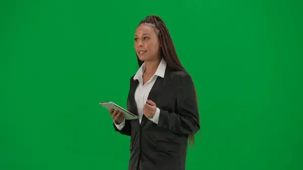 电视新闻报道和现场直播广告的概念 女性记者在彩色键绿色屏幕背景上被隔离 身着西装 拿着石碑的非裔美国女性新闻主持人 — 图库照片