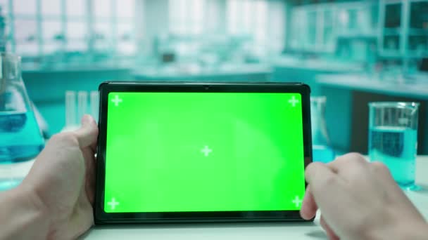 一个男人的手与平板绿色的彩色键屏相互作用 冷蓝色实验室背景 模板的位置为您的文字或形象 促销内容 广告区 模拟工作区 — 图库视频影像