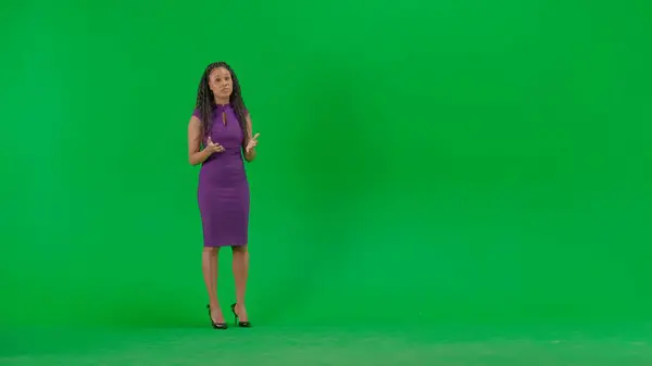 テレビニュースとライブ放送コンセプト クロマキーの緑色の背景に隔離されたドレスの女性 フルショットアフリカ系アメリカ人女性テレビニュースホスト立ってカメラを見ている — ストック写真