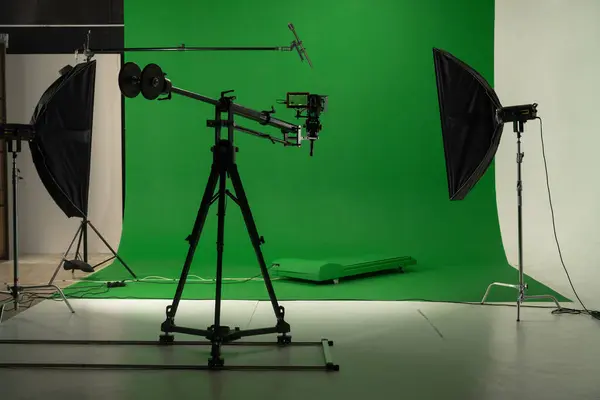 A well-equipped film studio featuring green screen and lighting for visual effects. Backstage shot.