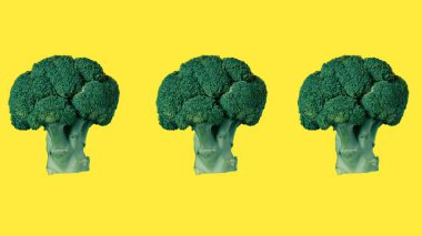 İzole edilmiş sarı arka planda yeşil brokoli çiçekleri deseni. Üç brokoli çiçeği. Ekran koruyucuları için mükemmel.