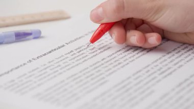 Bayan öğretmen ödevler için not veriyor. Profesyonel okul ya da üniversite öğretmeni öğrencilerin ödev sınav kağıtlarını not eder. Kadın kompozisyonu kontrol ediyor ve yanlış kelimeyi geçiyor, kırmızı kalemle düzeltiyor..