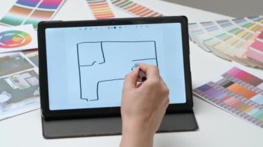 Tablet ve kalem kullanan kadın tasarımcı çizer. Kadın mimar ev tasarımcısı Stylus ile dijital grafik tablet üzerinde çalışıyor, yeni daire projesi çiziyor. Yaratıcılık ve modern teknoloji