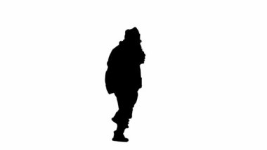 Noel ve yeni yıl tatili konsepti. Beyaz izole arka planda, Noel Baba kostümlü bir adamın siyah silueti. Noel Baba neşeyle yürüyor ve dans ediyor. Yarım dönüş.