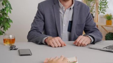 Hizmet ya da ürün için farklı ödeme türleri kullanan bir adam. Ofis masasında oturan bir işadamı nakit para veren bir adam cebinde tomar para saklar. Özel ticari ve iş ödemeleri.