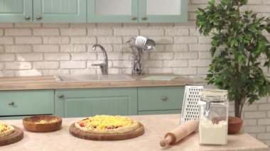 Mutfak yumuşak yeşil renklerde. Tezgahta pizza yapmak için yemek ve malzemeler var. Konforlu mutfak ve yemek hazırlama konsepti