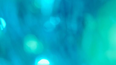 Colorful light leaks overlay. Blurred blue green lens flare motion studio lightning, garland with bokeh effect on dark background. Light leaks shining, abstract background footage. clipart