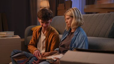 Genç bir adam ve bir kadın oturma odasında bir taşınma partisi hakkında konuşuyorlar. Birbirine aşık bir çift yere oturur ve evleri için yeni bir tasarım hakkında konuşur..