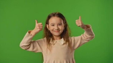 Çocuk duyguları konsepti. Küçük kız kameraya bakar ve el işaretlerini, olumlu ifadeyi gösterir. Krom anahtar yeşil ekran arka plan modelinde izole edilmiş..