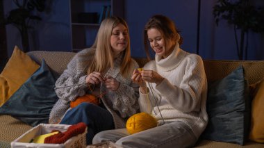 Geleneksel zanaat ve hobiler. İki bayan arkadaş geceyi evde hobi yaparak, kanepede oturup örgü örerek, iplik ve iğne kullanarak, sürecin tadını çıkararak, olumlu bir ifadeyle geçiriyorlar..