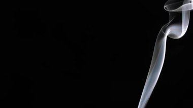 Beyaz dumandan oluşan zarif bir iz, doğal akıcılık ve hareketin göstergesi olarak karanlık bir arkaplana doğru yükselir. Yavaş çekim