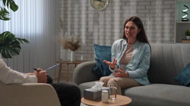 Günlük yaşam tarzı konsepti. Yaşlı yetişkin kadın zihinsel tedavi görüyor, kadın psikoterapiste gidiyor, kanepede oturuyor, sorunlarını anlatıyor, ağlayan surat ifadesi takınıyor. Yavaş çekim