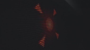 Bir ızgara üzerinde soyut turuncu desenleri gösteren dijital bir ekranın detaylı yakın plan görüntüsü modern, pikselli bir sanat efekti yaratıyor. Makro