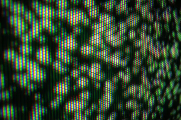 Ekranda RGB piksellerini gösteren bir makro çekim, dijital görüntülerin canlı renklerini ve ızgara yapısını gösterir.