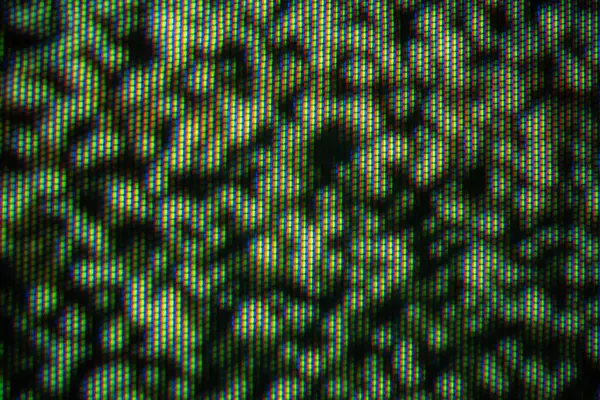 Pikselleştirilmiş bir TV ekranının yakın plan görüntüsü, canlı renklerde durağan bir sesin soyut bir modelini gösteriyor..