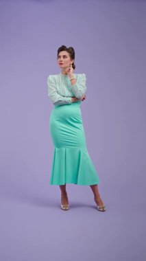 Klasik kıyafetli, çekici saç stili olan genç bir kadın mor stüdyo geçmişinde poz veriyor. Retro tarzında güzel bir aktris bir şey düşünüyor ve hiçbir fikri olmadığı için üzülüyor. Güzellik ve eski tarz konsept.