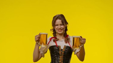 Geleneksel elbiseli gülümseyen genç kadın elinde iki büyük bardak bira tutuyor. Parlak sarı arka plan şenlik havasını arttırır..