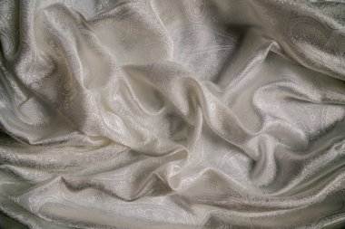 Şık desenli, zarif bir desenli kumaş, zarafeti ve zarafeti vurgulamak için zarifçe örtülmüş. Makro