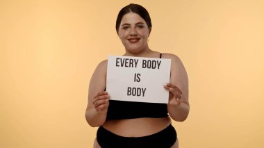 Bir kadın güçlü bir sig tutar. Vücut, vücudun pozitifliğini destekler, kendini sevmeyi ve kişisel yetkilendirmeyi destekler..